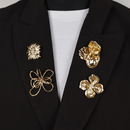 Brooches and pin on black blazer