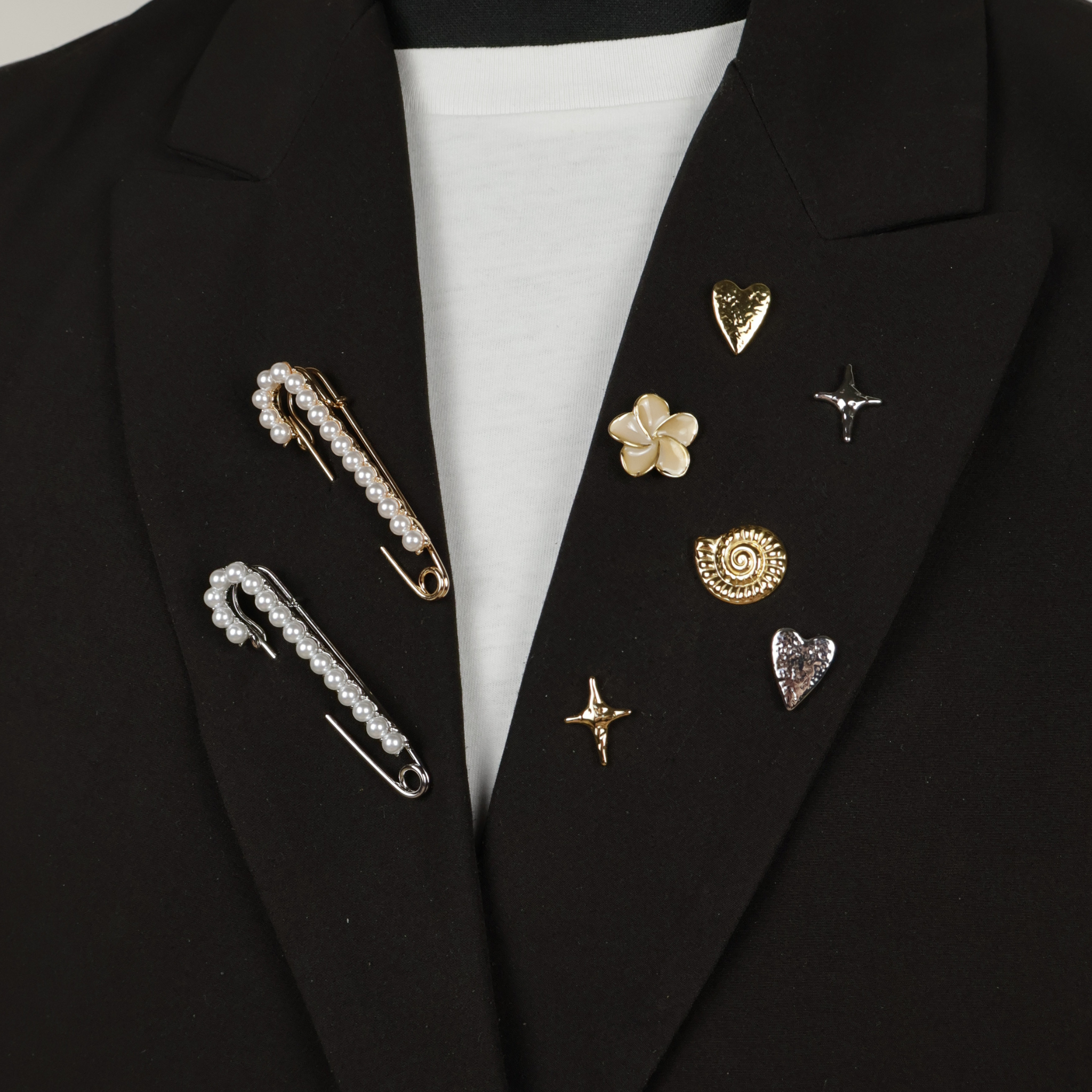 Brooches and pin on black blazer
